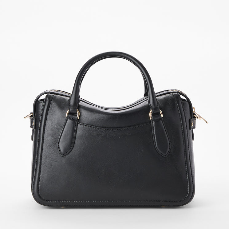 Brahmin black handbag with two top handles, gold-tone hardware, and a structured silhouette. Features a smooth texture, simple design, and is displayed against a white background. No shoulder strap visible.