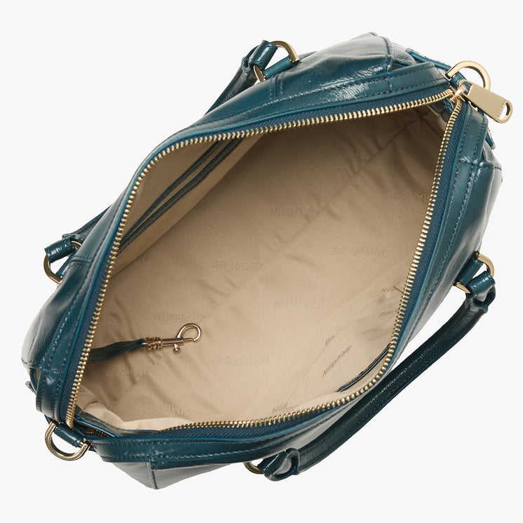 Brahmin teal leather handbag with gold zipper, shown open to display beige lining, an interior zip pocket, and a small gold clasp on a short strap; features structured silhouette and shiny gold hardware.