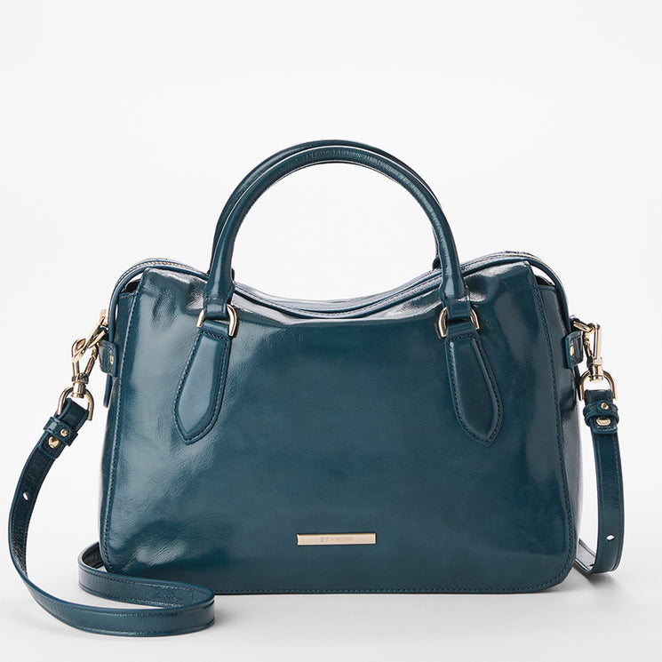 Brahmin handbag in shiny teal leather, satchel silhouette with dual top handles and detachable shoulder strap, gold-tone hardware, small front rectangular nameplate, textured finish; front view.