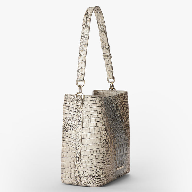 Silver metallic Celina handbag with crocodile texture on a white background. Side view.
