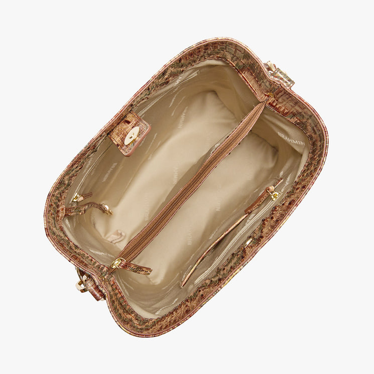 A shoulder bag with a textured crocodile skin pattern in shades of brown, beige, and muted green, featuring a gold Brahmin plaque on the front. Celina Open Top View.