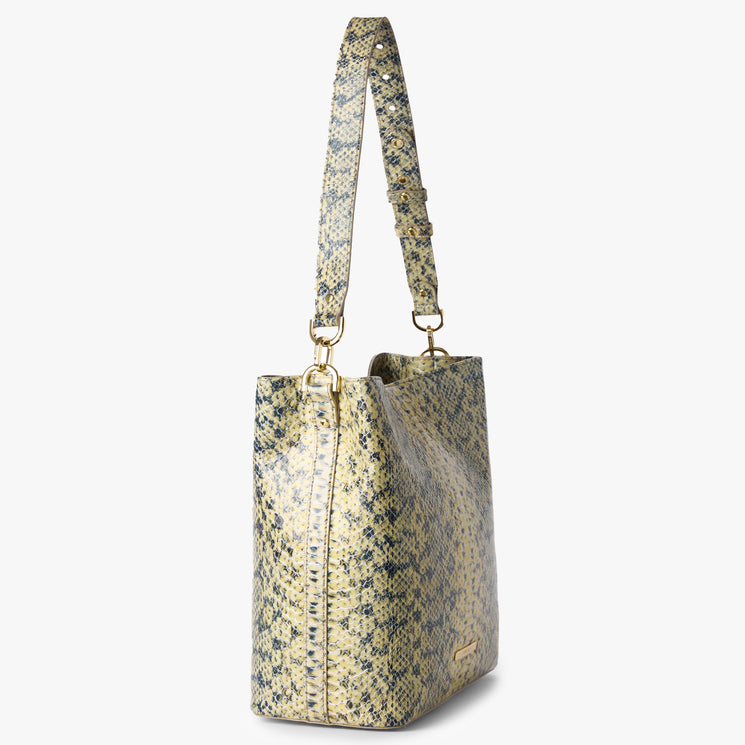 Brahmin yellow and gray handbag with embossed snakeskin-inspired pattern, gold hardware, wide adjustable shoulder strap; side view highlights structured silhouette against plain white background.
