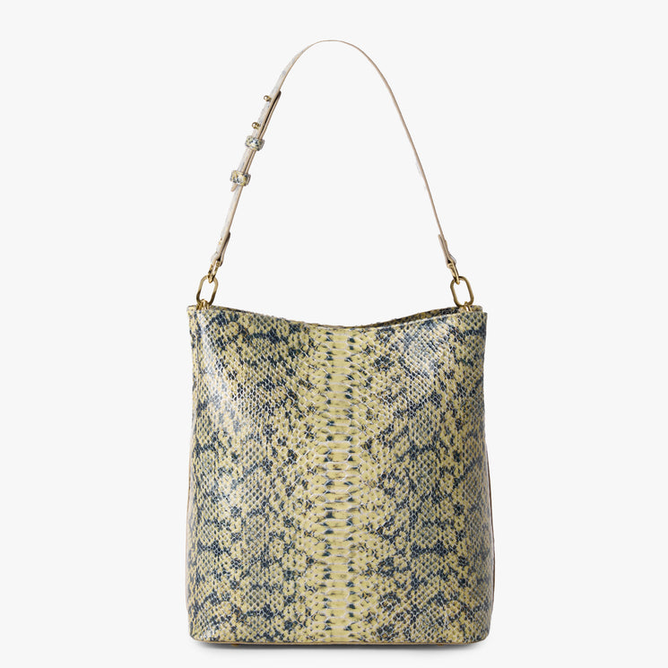 Brahmin structured bucket bag in yellow and dark blue embossed pattern, beige adjustable shoulder strap, sleek silhouette with gold-tone hardware, shown upright on a white background.