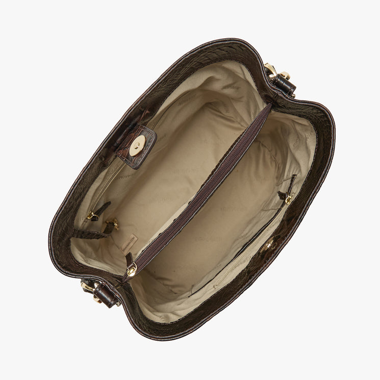 Top view of an open Brahmin brown leather handbag with beige fabric lining, central zippered pocket divider, gold-tone hardware, and structured silhouette. Handbag is empty and displayed against a white background.