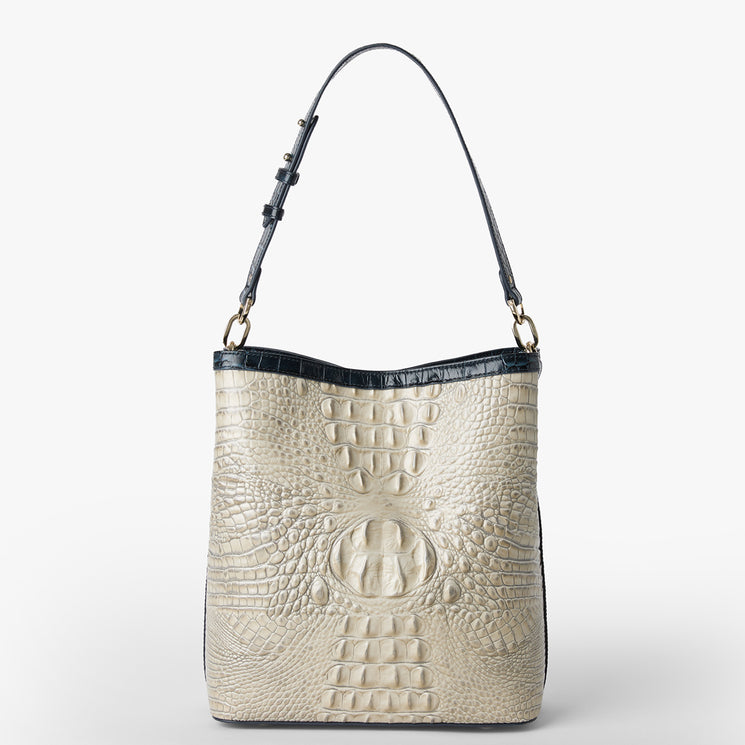 Brahmin cream-embossed leather shoulder bag with black adjustable strap and trim, structured silhouette, subtle textured pattern, gold-tone hardware, displayed on a white background.
