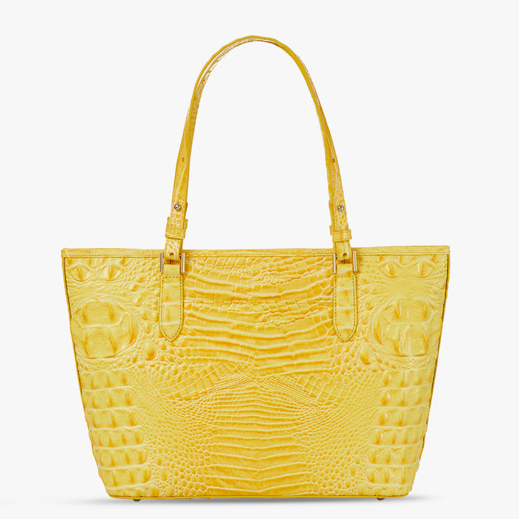 Brahmin yellow tote bag with embossed texture, structured silhouette, two matching shoulder straps, gold-tone hardware, and flat base; displayed on a plain white background.