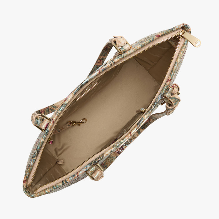 An open floral-patterned handbag shown from a top-down perspective, revealing a beige interior lining and gold-tone hardware on a light gray background.