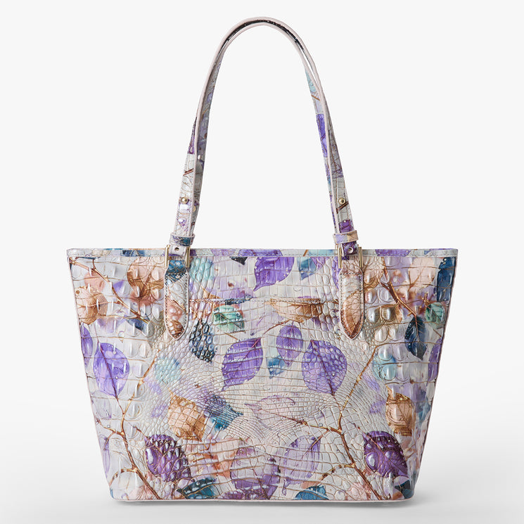 Brahmin textured tote bag with embossed pattern, pastel floral print in purple, blue, and tan. Features two shoulder straps. Shown on a white background, front view.