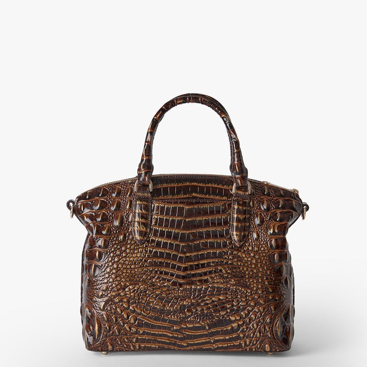 A structured brown crocodile-embossed leather handbag with double top handles, shown against a plain light gray background. Duxbury satchel back view.