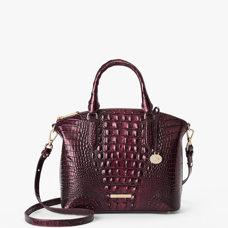 A dark burgundy crocodile-embossed leather handbag with gold-tone hardware, dual top handles, and a detachable shoulder strap, shown on a clean white background.