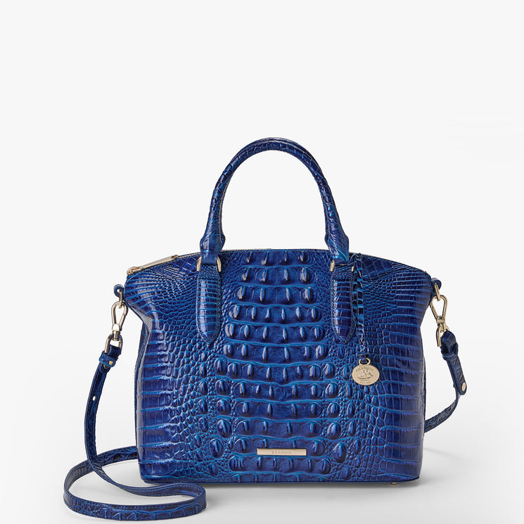 Brahmin blue embossed leather handbag with gold-tone hardware, two top handles, detachable shoulder strap, structured silhouette, and textured pattern, shown on a white background.