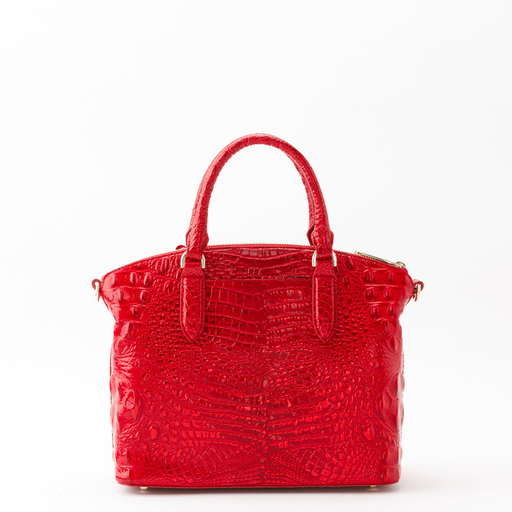 Holiday red Brahmin Duxbury satchel featuring a shiny, croc-embossed texture, two top handles, and gold-tone hardware.