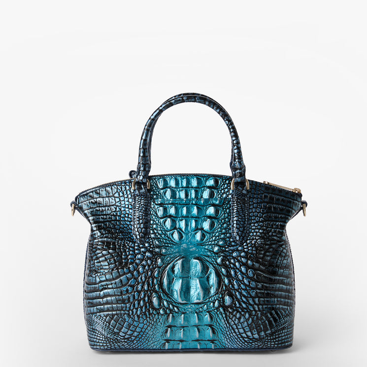 Brahmin blue textured handbag with an embossed pattern, two top handles, structured silhouette, silver hardware accents, and glossy finish, displayed on a white background.