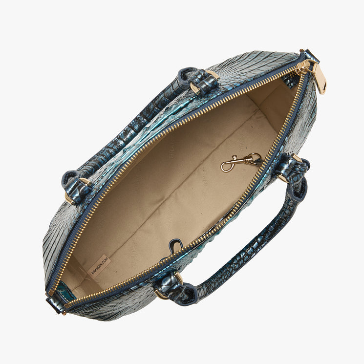 Brahmin blue textured satchel with gold zipper, two top handles, and embossed pattern. Shown open from above on white background, revealing beige fabric-lined interior and metal clip detail.