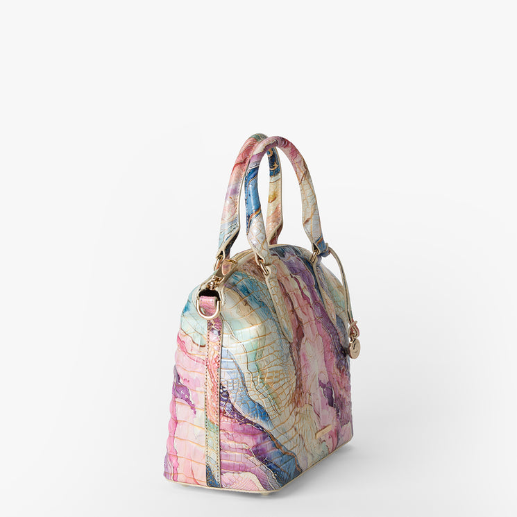 Colorful handbag with a marbled pattern on a white background. Duxbury satchel side view.