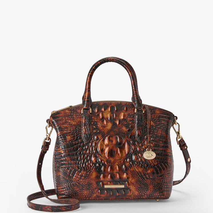 A brown embossed crocodile-pattern leather handbag with dual top handles, a detachable shoulder strap, and gold-tone hardware, photographed on a clean white background.