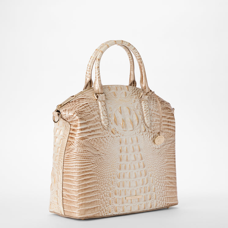 A structured Large Duxbury handbag in textured crocodile-embossed leather, featuring dual top handles and a circular embossed logo on the front, shown against a plain white background. Side view.