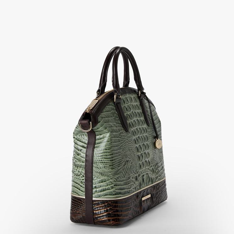 A structured handbag with a textured sage green crocodile-embossed upper body and dark brown leather trim, handles, and base, accented by gold-tone hardware.