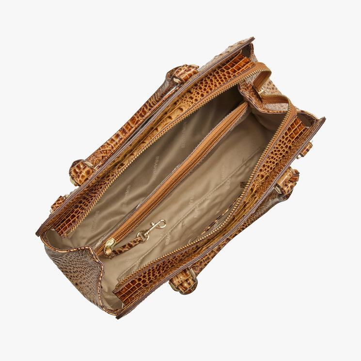 Brahmin brown embossed handbag with structured silhouette, gold-tone hardware, top handles, and beige-lined interior featuring zip pocket, open compartments, and key leash. Overhead view on white background.