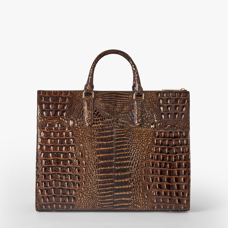 A structured brown crocodile-embossed leather handbag with dual top handles, photographed against a clean light gray studio background. Back view.