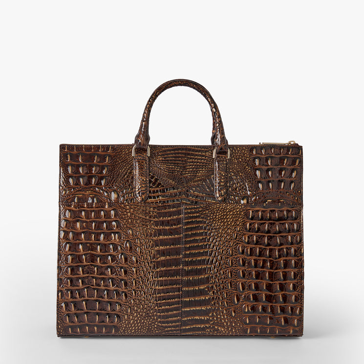 A structured brown crocodile-embossed leather handbag with dual top handles, photographed against a clean light gray studio background. Business tote back view.