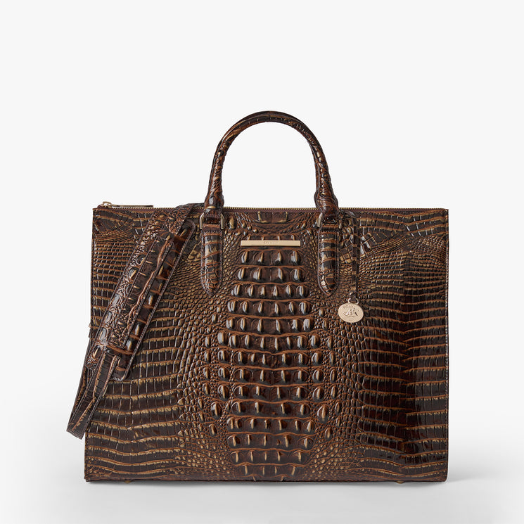 A structured brown crocodile-embossed leather handbag with dual top handles and a detachable shoulder strap, shown on a clean light gray background. Business tote front view with strap.