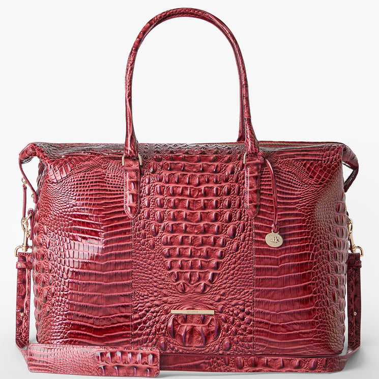 Brahmin red embossed leather satchel handbag with dual top handles, detachable shoulder strap, gold-tone hardware, and small round logo charm. Structured silhouette shown on white background.