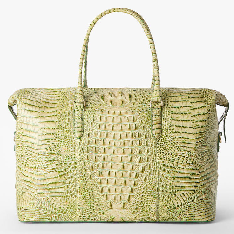 Brahmin handbag in light green with structured silhouette, embossed textured pattern, two top handles, gold-tone zipper closure, and front view highlighting the signature symmetrical design.