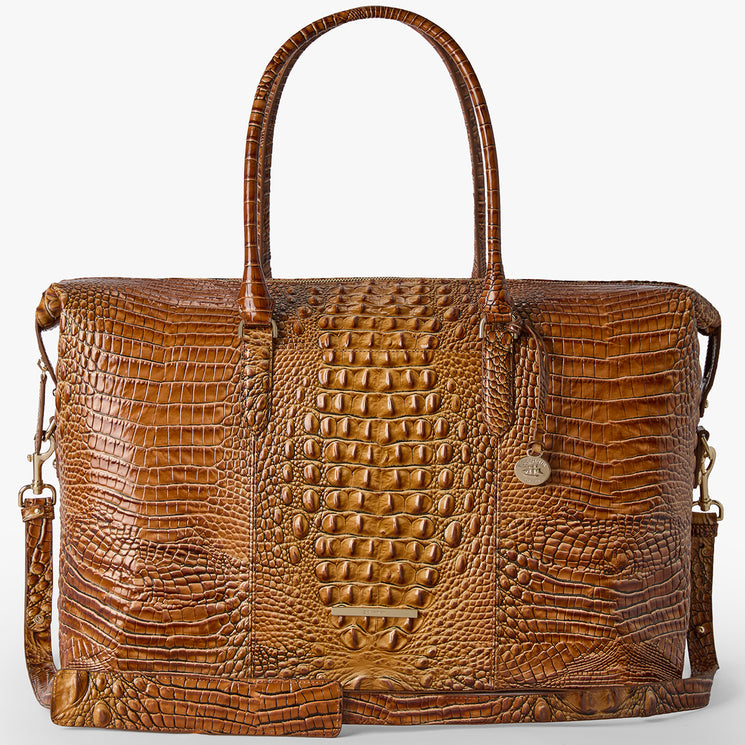 Brahmin brown textured leather tote bag with two top handles, a detachable shoulder strap, gold-tone hardware, and a small round Brahmin charm. Structured silhouette shown from the front.
