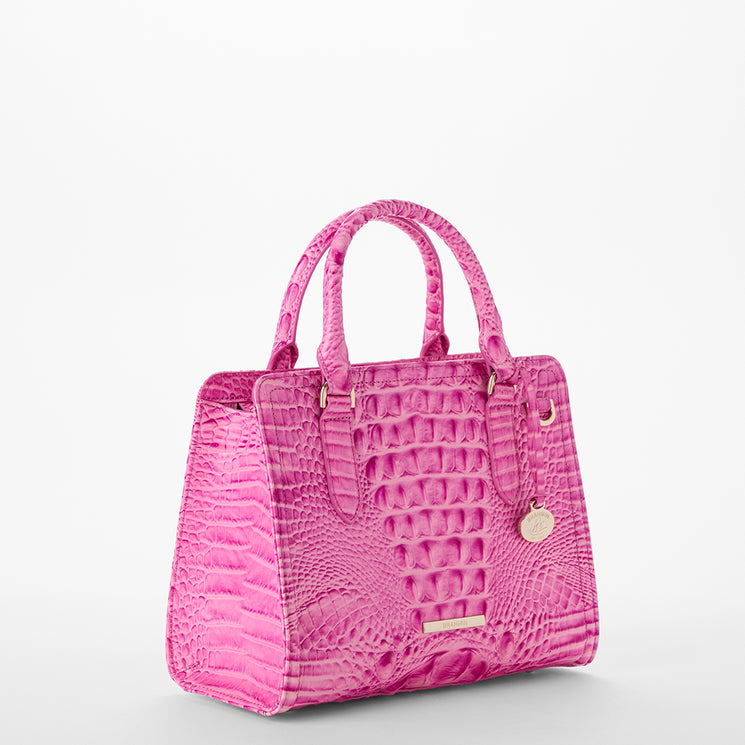 Pink textured Cami handbag on a light gray background side view