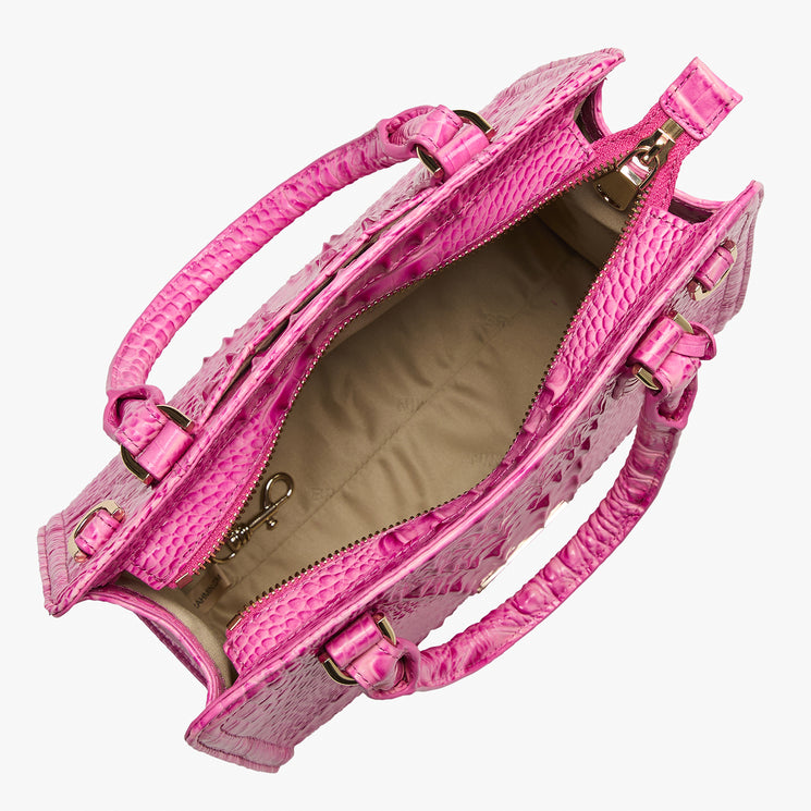 Pink Cami handbag with gold accents on a white background open top view