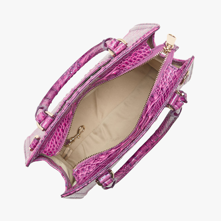 Brahmin handbag top view showing pink textured exterior, beige interior with gold zipper, attached key chain clip, and two sturdy handles. Silhouette is structured and open; perfect for shoulder or hand carry.