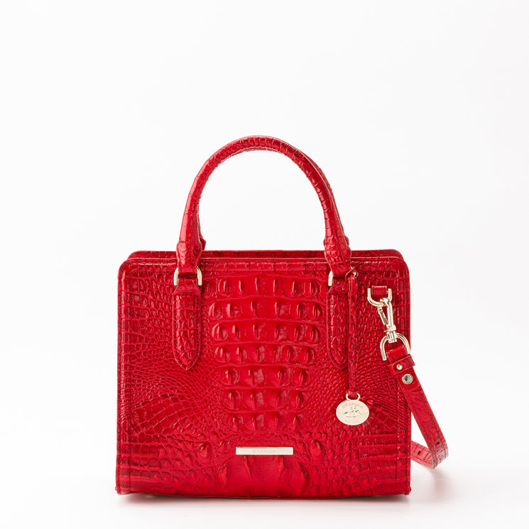 Brahmin Cami satchel in red featuring a glossy, croc-embossed texture and square silhouette. Designed with gold-tone hardware, two top handles, and a detachable shoulder strap.