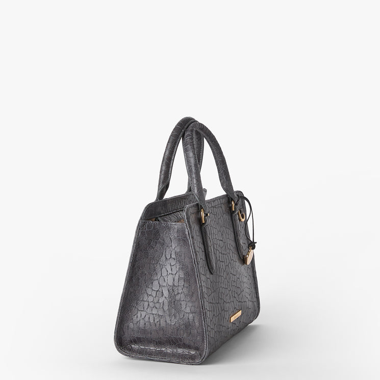Brahmin dark gray textured handbag with gold hardware, double top handles, and structured silhouette, shown angled left on a white background. Features embossed pattern and visible seam details.