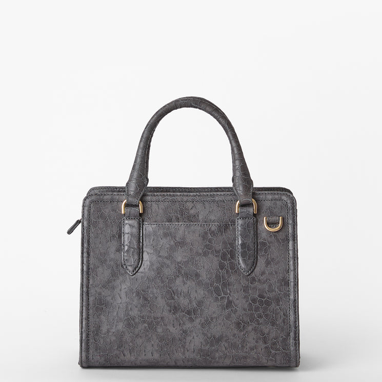 Brahmin gray textured satchel with double top handles, gold-tone hardware, and a front slip pocket, shown against a white background. Structured silhouette and subtle embossed finish are visible.