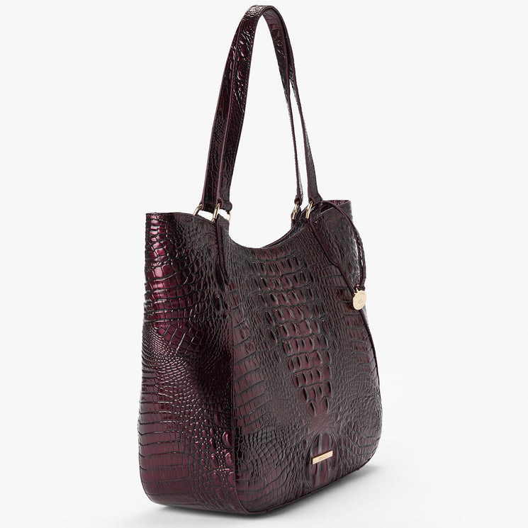 A dark burgundy crocodile-embossed leather tote bag with double shoulder straps and small gold-tone hardware, shown on a clean white background.