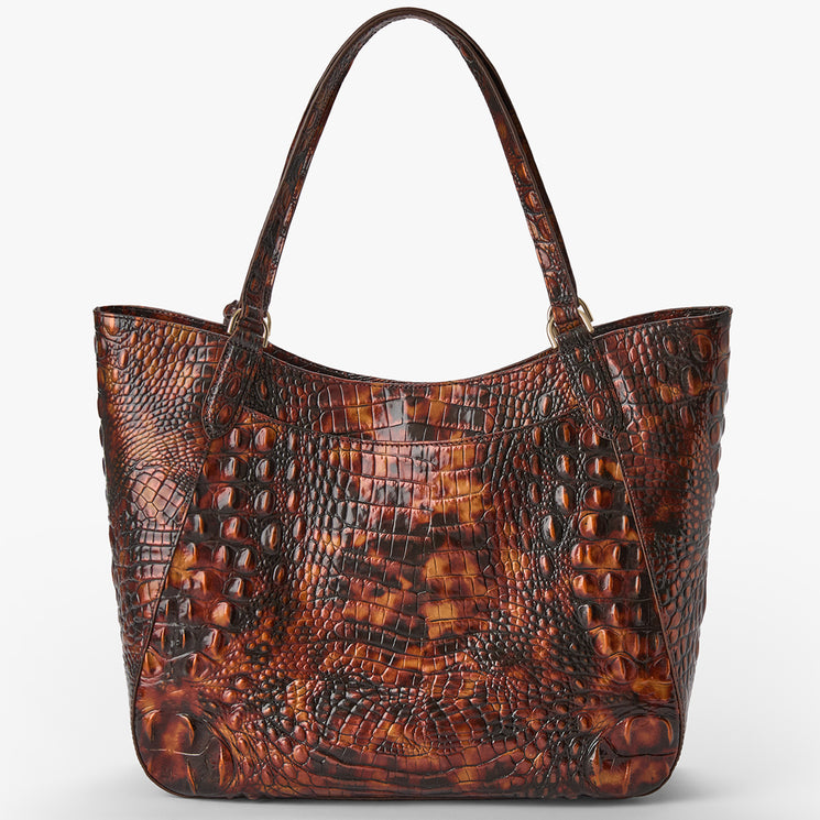 A brown crocodile-embossed leather tote bag with dual shoulder straps and gold-tone hardware, shown against a plain light gray background.