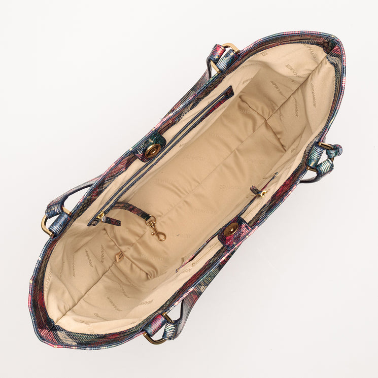 Top-down view of an open BRAHMIN Aliza tote in holiday plaid, featuring gold-tone hardware, light tan lining, an interior zip pocket, and a lobster claw key clip.