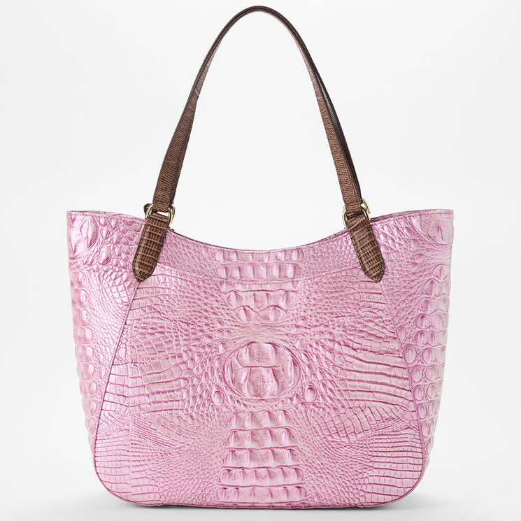 Brahmin pink tote bag with textured, crocodile-embossed finish, featuring brown shoulder straps and gold hardware, shown against a white background. Structured silhouette highlights the spacious design.