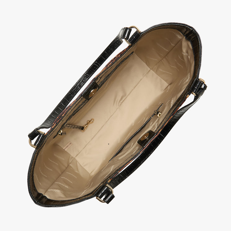 An overhead view of a black crocodile-embossed handbag showing its beige interior lining with a zipper compartment and gold-tone hardware, set against a plain white background.