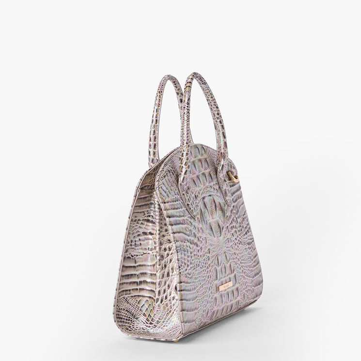 Brahmin iridescent structured handbag, side view, with two top handles and crocodile-embossed texture. Shown against a white background; features a sleek silhouette and metallic hardware.