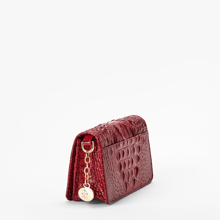 Volcanic Red Melbourne croc textured handbag on a light gray background. Minuette side view.