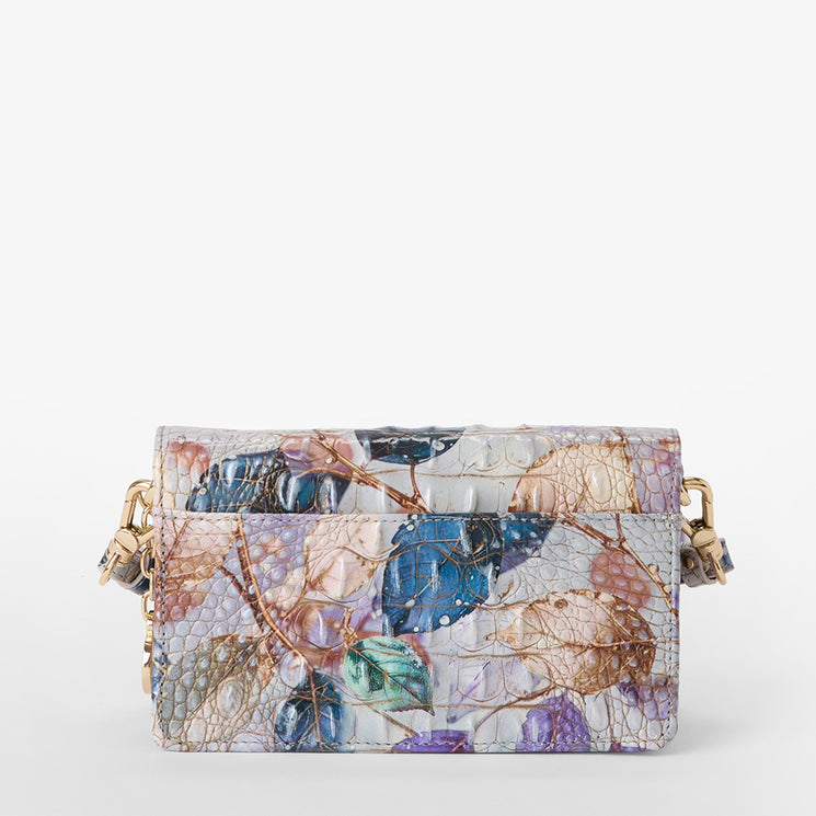 Brahmin small rectangular purse in a textured finish with gold clasp and chain strap, displaying a vibrant leaf pattern in blue, purple, green, and brown on a light background. Shown from the front.