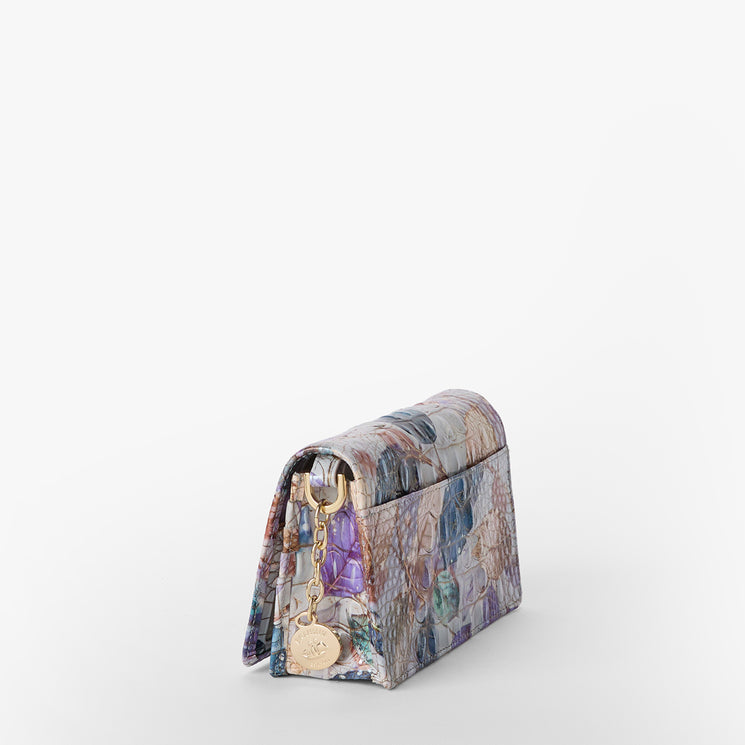Brahmin structured handbag with a multicolor textured pattern, gold chain strap, and gold-tone charm. Shown angled to display the side and front silhouette on a plain white background.