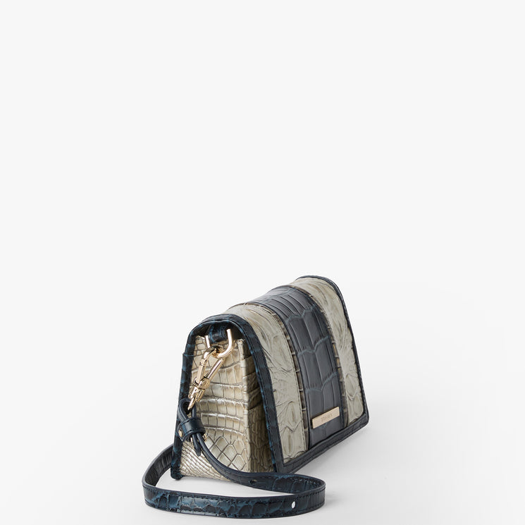 Brahmin small structured handbag in gray and navy tones with textured embossed pattern, gold chain strap and hardware, top handle silhouette, displayed on a plain white background.
