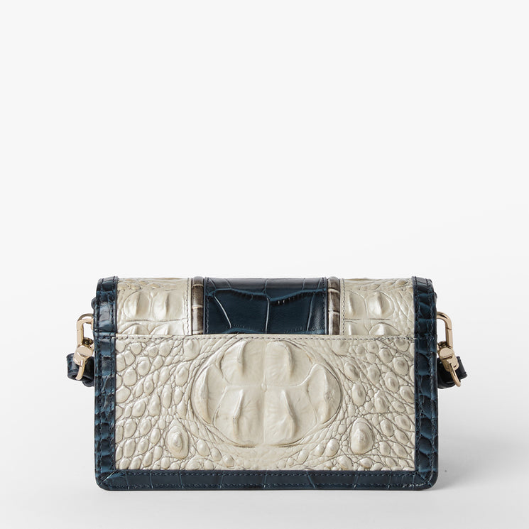 Brahmin small rectangular handbag with embossed cream textured pattern, dark blue trim, gold hardware, and a structured silhouette. Features top handles, elegant design, and visible Brahmin branding.