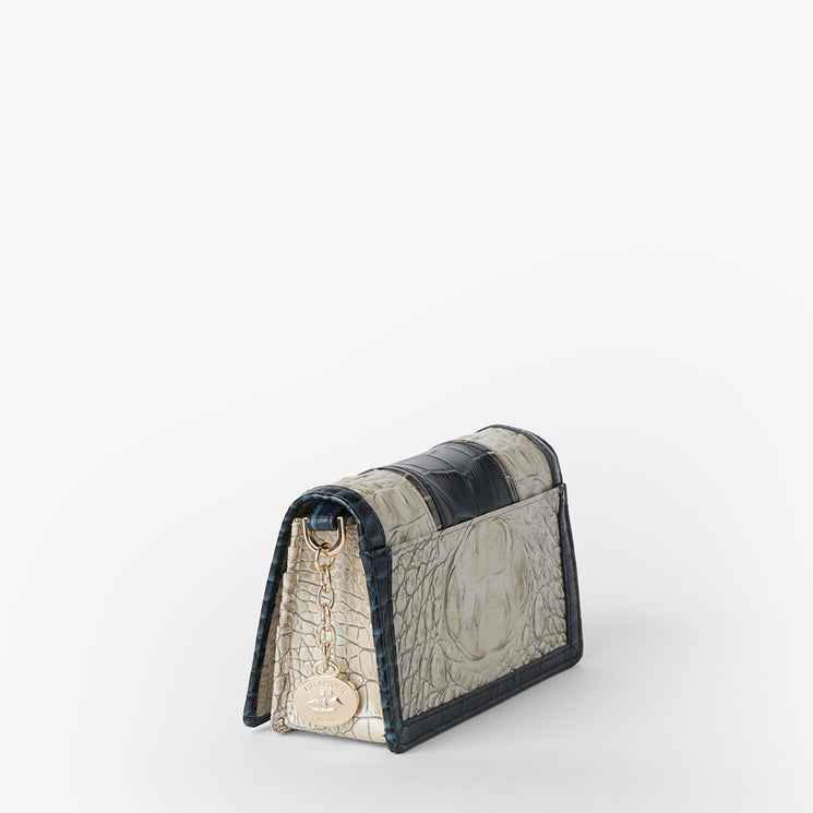Brahmin small gray and black textured handbag with gold-tone chain strap and tag, structured silhouette, subtle embossed pattern, displayed from a rear side angle on a white background.