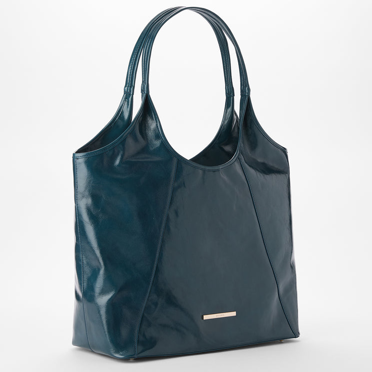 Brahmin dark teal tote bag with double handles, shiny smooth texture, rectangular metallic logo plate on the front, structured silhouette, shown against a white background.