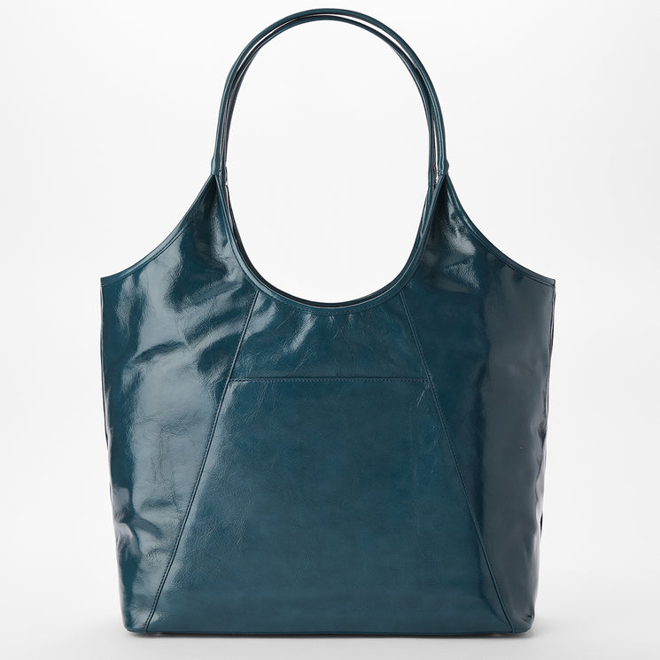 Brahmin glossy teal tote bag with two shoulder-length handles, front patch pocket, and subtle textured finish. Shown upright on a plain white background, highlighting silhouette and hardware details.