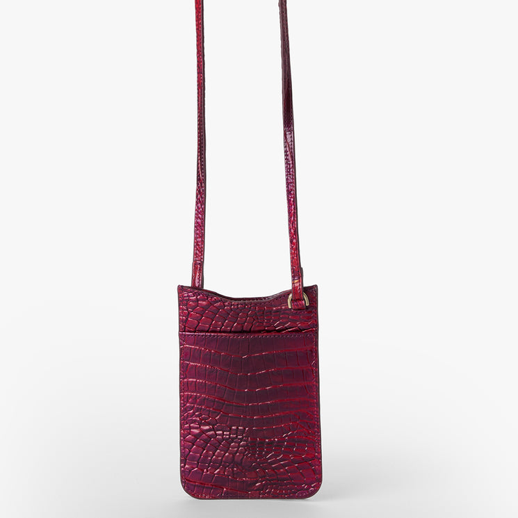 BRAHMIN Eris small crossbody phone pouch in deep red with a textured crocodile-inspired pattern, long adjustable strap, slip top opening; shown upright against a plain white background.
